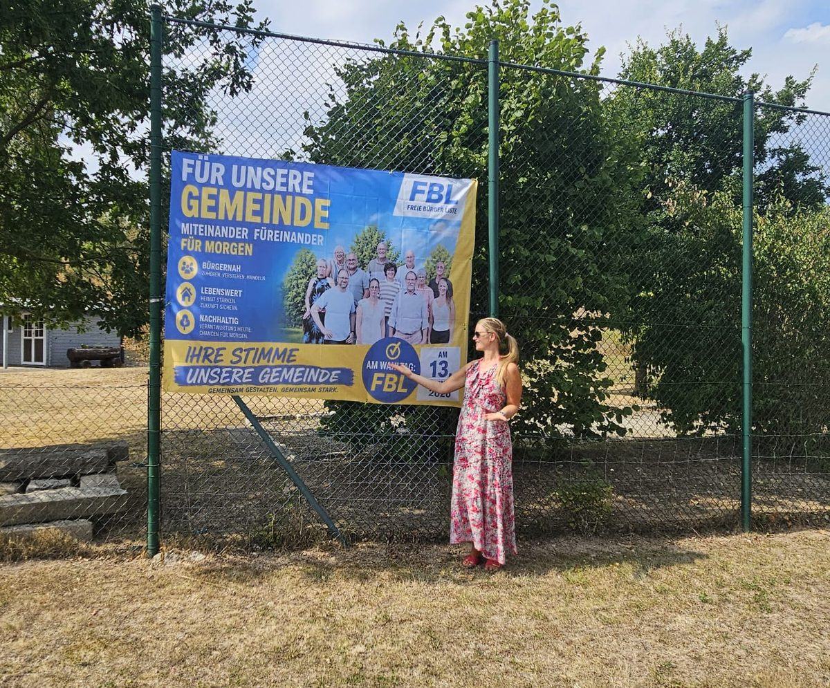 Katharina Nülsen vor dem FBL-Banner am Ortseingang Elvese